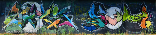 The old wall, painted in color graffiti drawing with aerosol paints. Background image on the theme of drawing graffiti and street art