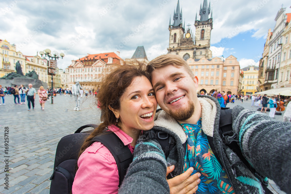 tourists couple taking selfie on city street. Vacation, love, travel and holiday concept.