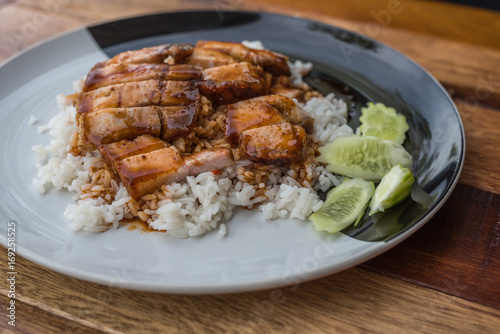 Barbecued red pork in sauce with rice and cucumber