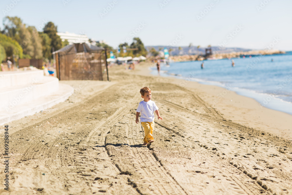 Little boy playing on a beach in summer vacation Little boy playing on a beach in summer vacation