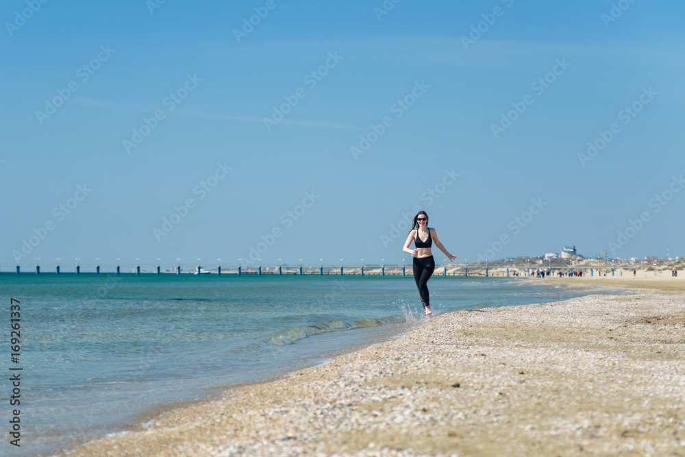 Beautiful young woman Jogging on the beach