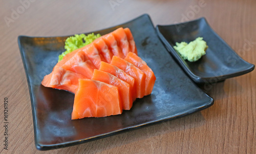 Salmon sashimi served with wasabi.