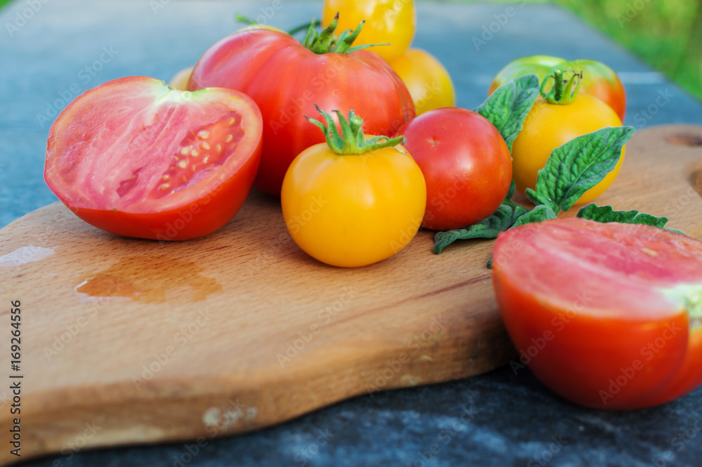 Yellow and red tomatoes on the board Yellow and red tomatoes on the board
