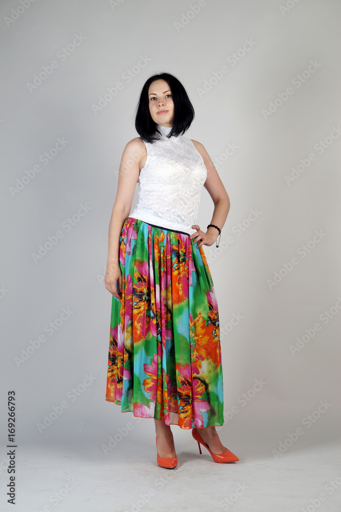 Beautiful young girl posing on a grey background Beautiful young girl posing on a grey background