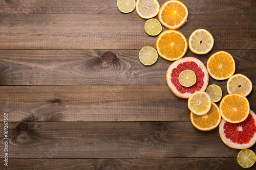 Citrus fruits. Oranges, limes and lemons. Over wood table background with copy space