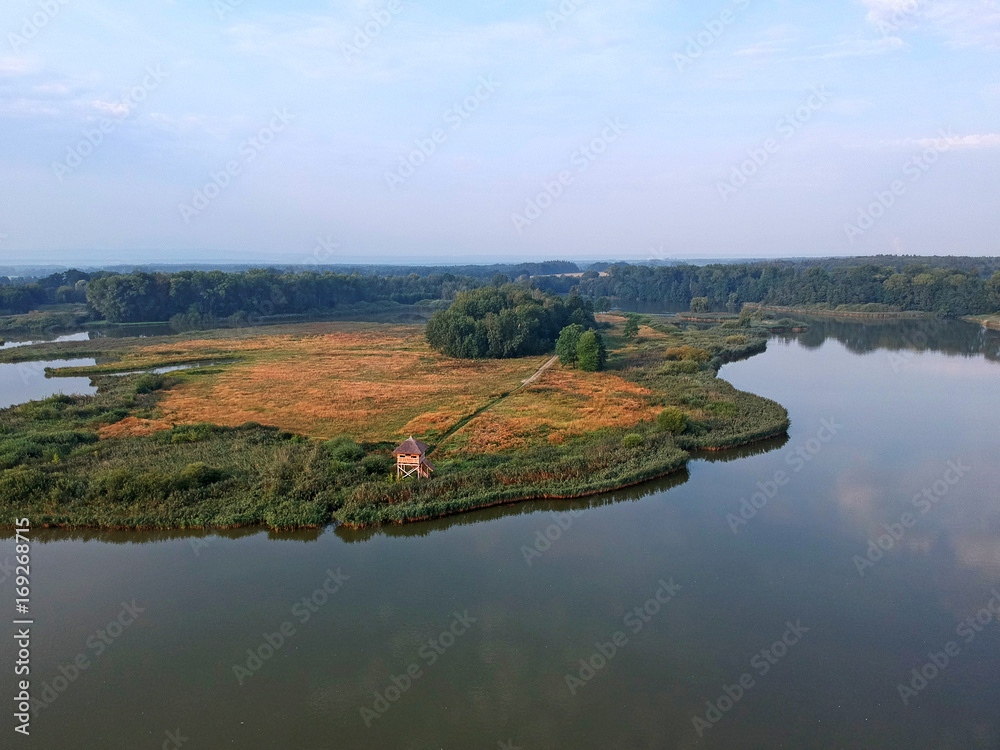 Beautiful summer morning landscape with lake, forest and birdwatching tower from airplane in central Europe - Czechia