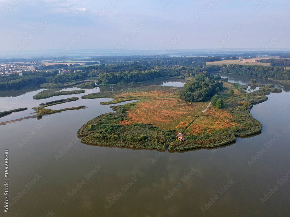 Beautiful summer morning landscape with lake, forest and birdwatching tower from airplane in central Europe - Czechia