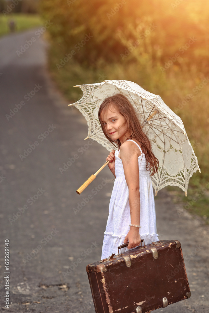 Happy girl with umbrela on the rainy day