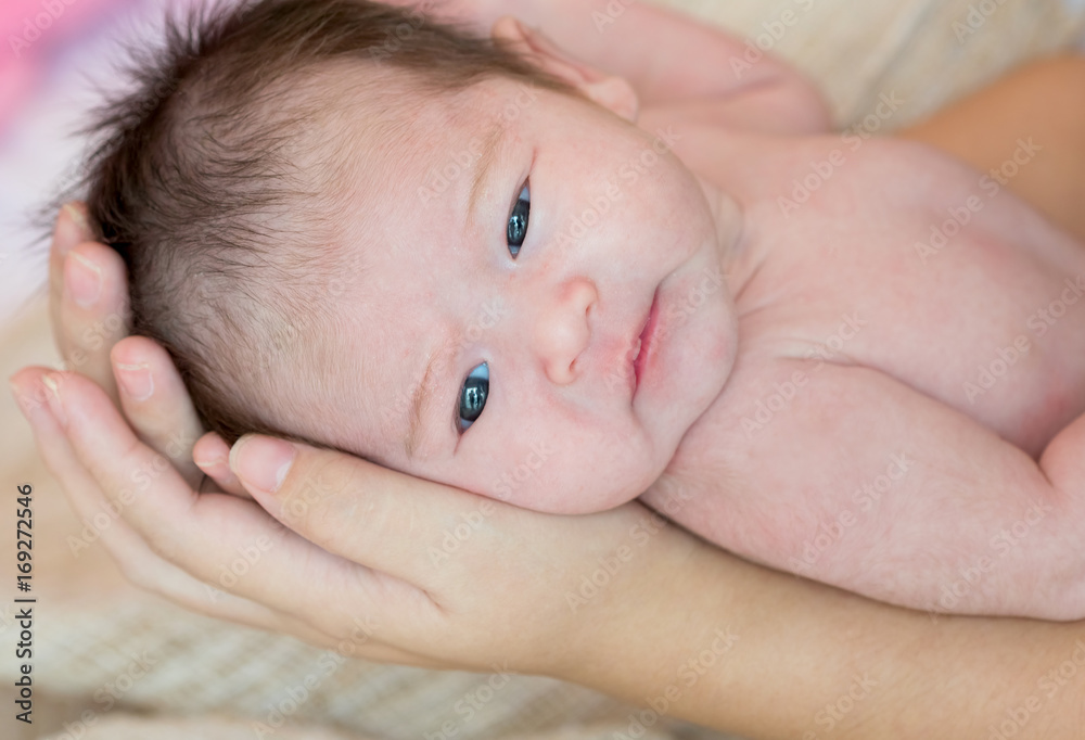 Mother hand holding cute newborn baby girl Mother hand holding cute newborn baby girl
