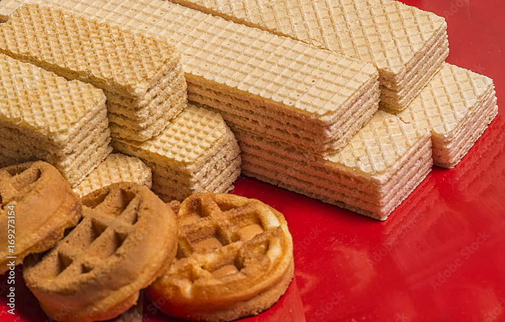 Fresh waffles on a red plate to the day of waffles Fresh waffles on a red plate to the day of waffles