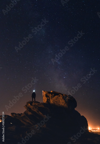 Silhouette under a starry sky