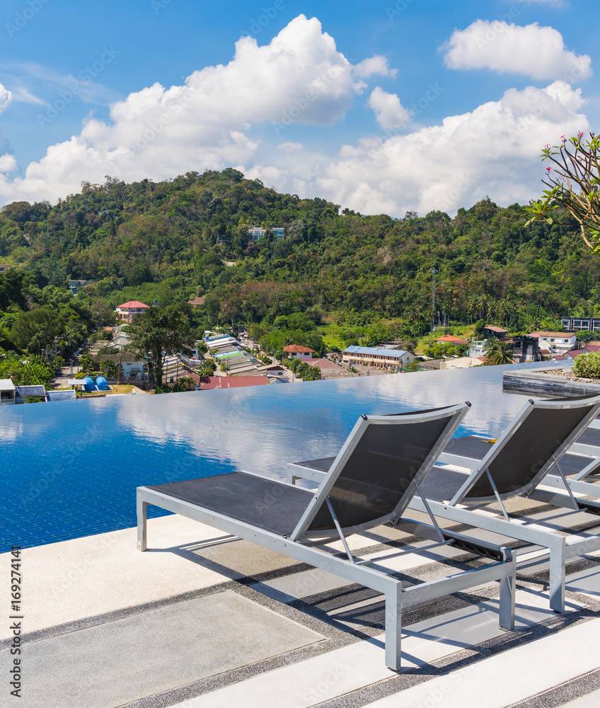 Fototapeta premium Sunbeds near swimming pool on the top roof