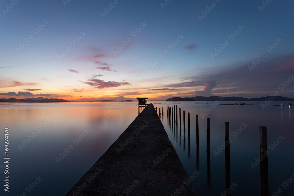 scenery view of old jetty to the sea beautiful sunrise or sunset in phuket thailand.