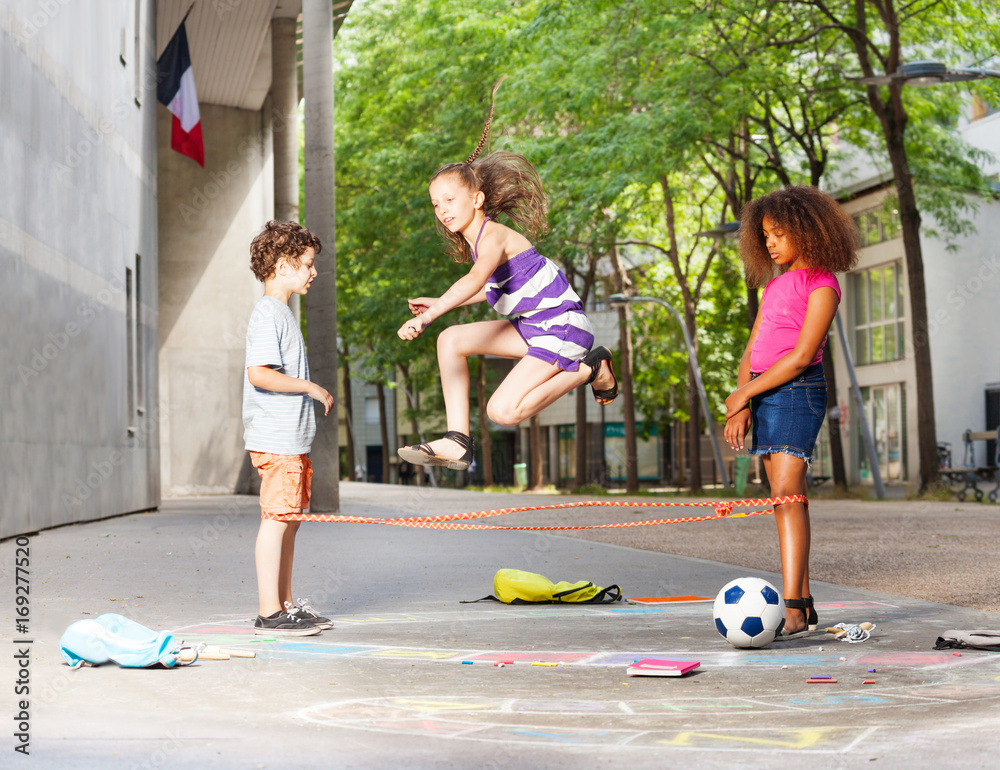 Group of kids play Chinese jump rope game StockFoto Adobe Stock
