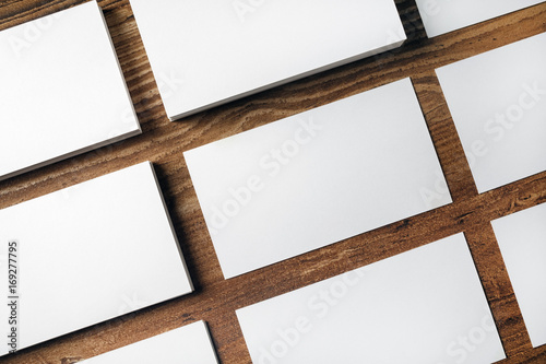 Many blank business cards on wooden background. Mockup for ID. Top view.