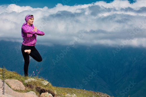 Woman doing yoga in beautiful mountains