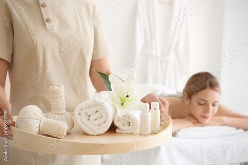Masseuse holding tray with ...