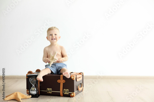 Cute baby boy sitting on tr...