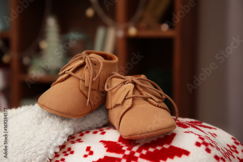 Baby booties on blurred background. Christmas concept