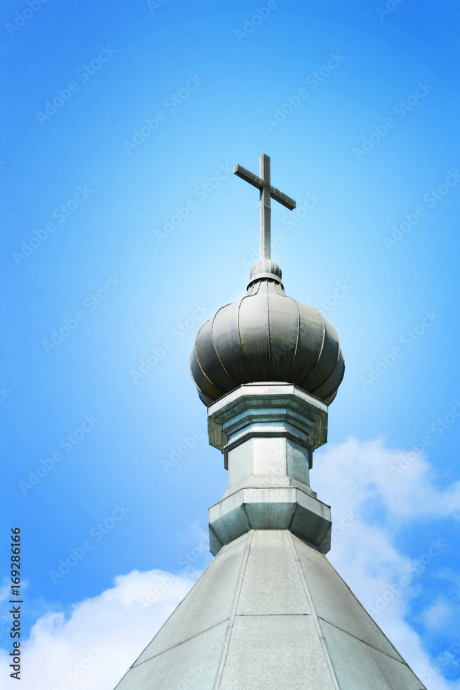 dome with a cross at cloudy skies background
