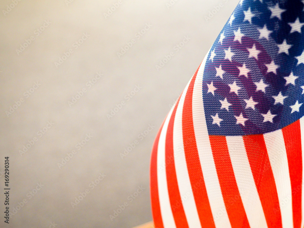 Obraz premium American flag on the table, part overexposed and blurry, the independence of America, the great power USA