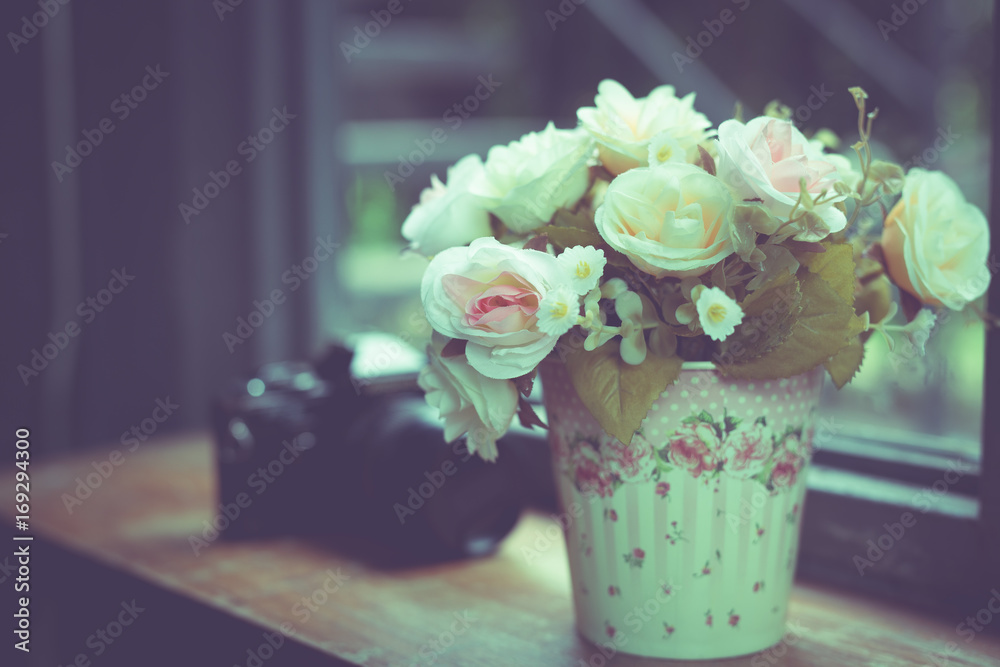 Artificial Flowers in the vase at the window,vintage filter