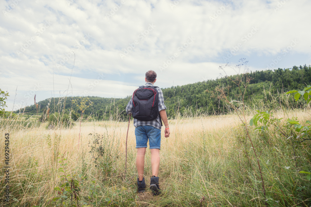 Young hiker in nature / wilderness - trekking outdoors. Young hiker in nature / wilderness - trekking outdoors.