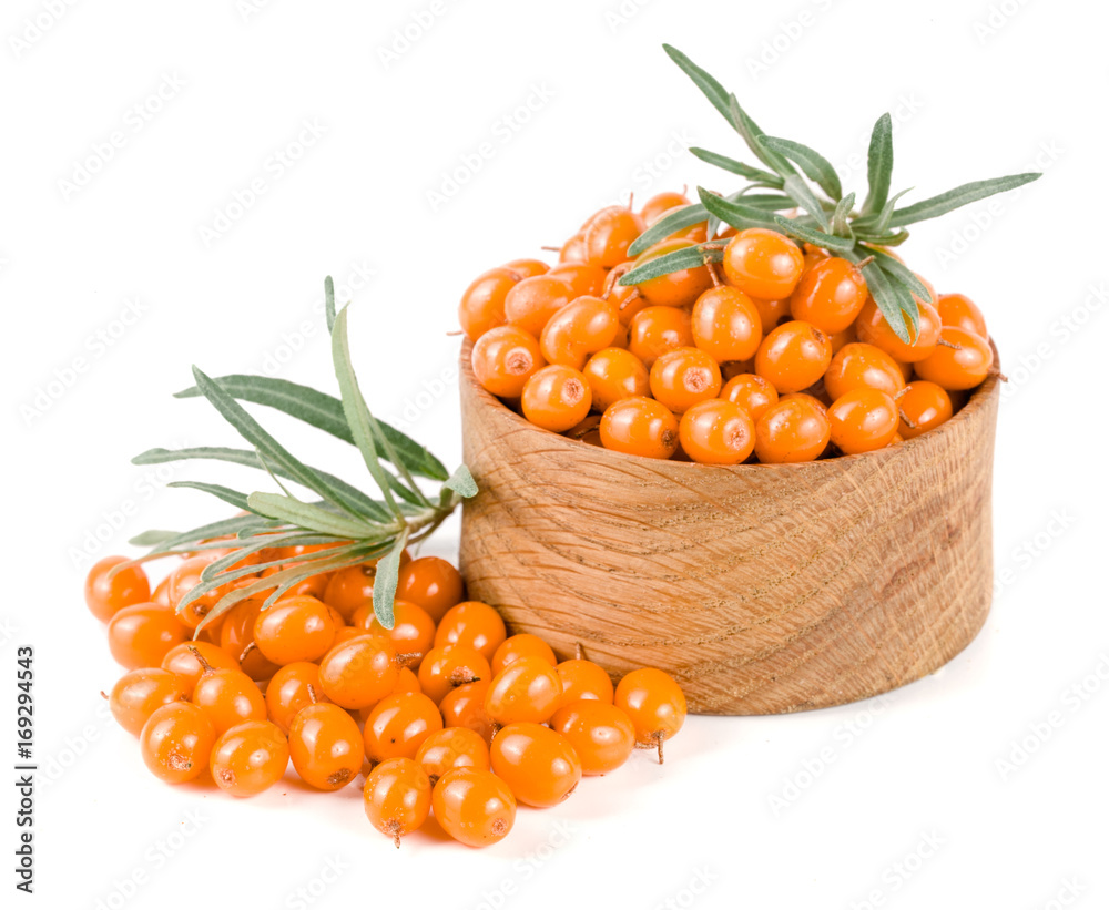 Sea buckthorn. Fresh ripe berry with leaves in a wooden bowl isolated on white background macro Sea buckthorn. Fresh ripe berry with leaves in a wooden bowl isolated on white background macro