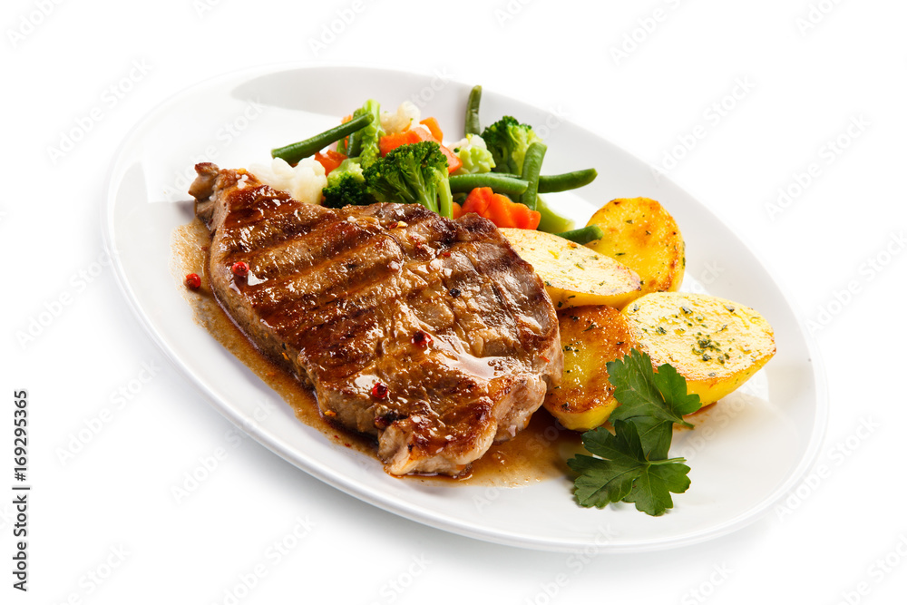 Grilled beefsteak with broccoli and carrot on white background