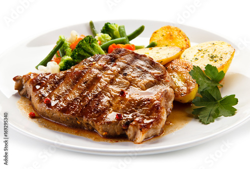 Grilled beefsteak with broccoli and carrot on white background