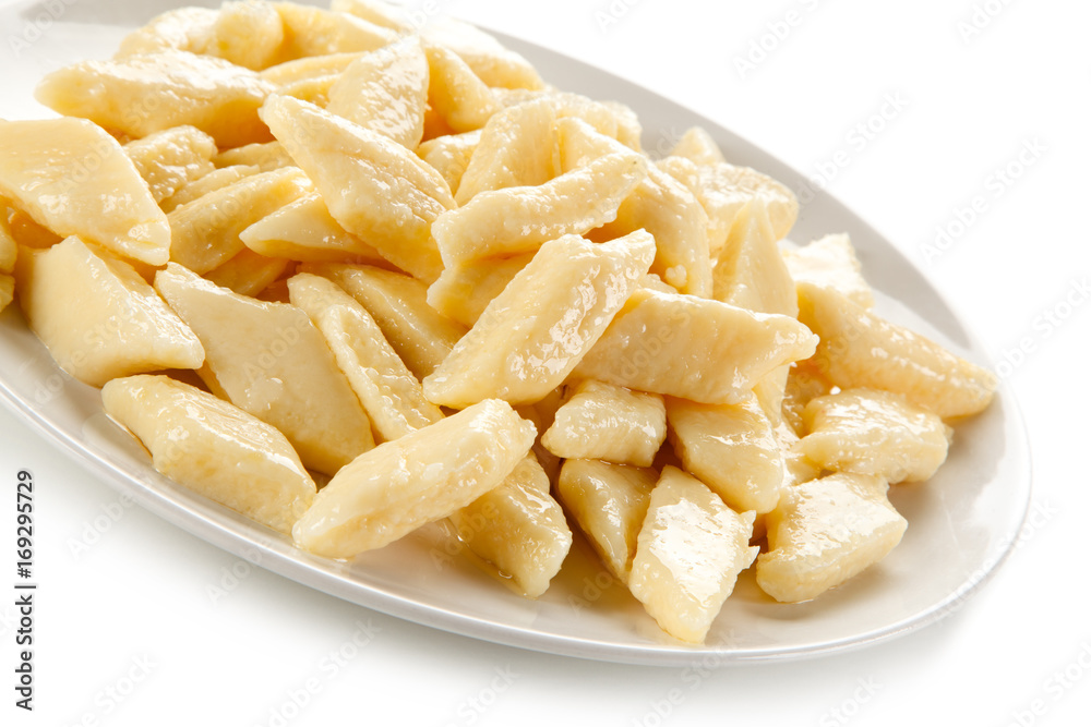 Potato noodles - dumplings on white background Potato noodles - dumplings on white background