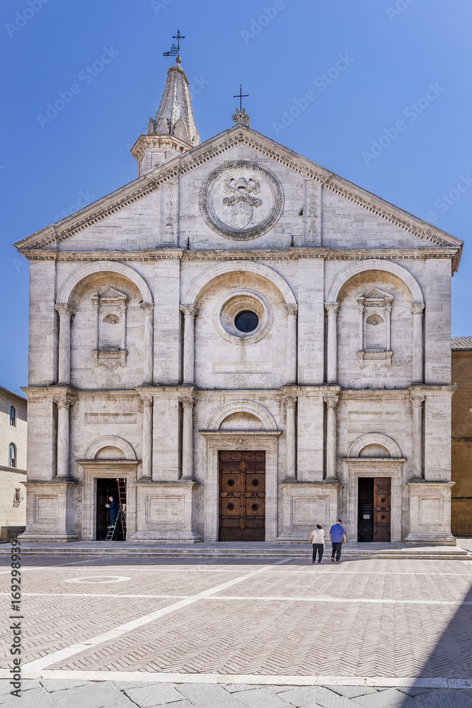The stunning facade of the Duomo di Santa Maria Assunta cathedral, Pio II square, in the historic center of Pienza, Siena, Italy on a sunny day