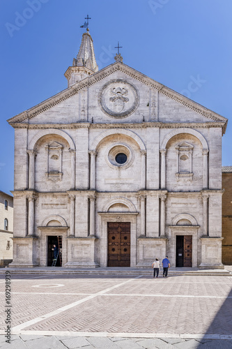 The stunning facade of the Duomo di Santa Maria Assunta cathedral, Pio II square, in the historic center of Pienza, Siena, Italy on a sunny day