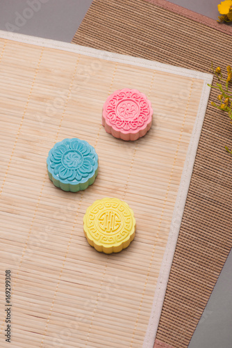 Traditional mooncakes on table setting. Snowy skin mooncakes. Chinese mid autumn festival foods.