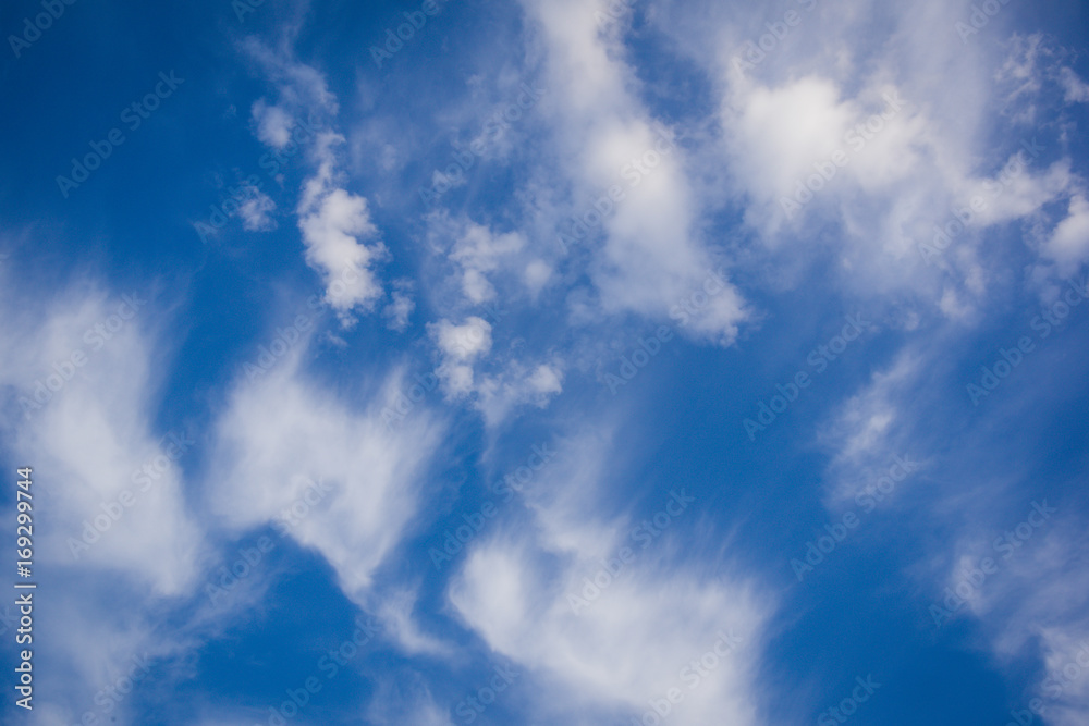 Fantastic soft fluffy white wind blurred clouds on blue sky. Use for background.