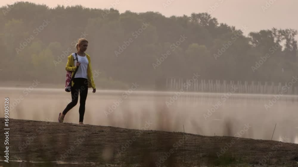 Young woman walking on the beach in the morning Young woman walking on the beach in the morning