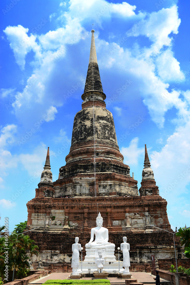 Beautiful pagoda and white buddha with sunny blue sky at Ayutthaya in Thailand