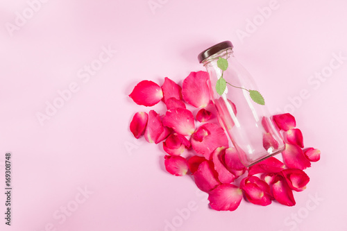 bottle and rose petals On the pink background  © kesornphoto