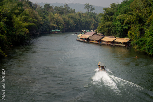 Boat getting through the river Kwai in Sai Yok national park, Kanchanaburi, Thailand © jumpscape