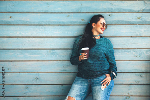 Plus size woman walking on the city street photo