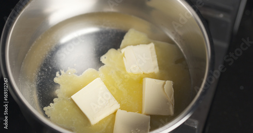 melting butter in pot close up photo