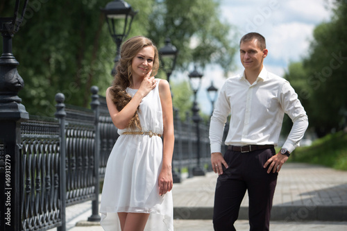 A love couple, husband and wife, models stroll on a summer day. Relations, love, family values, wedding.