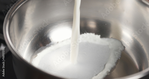 shot of pouring milk into saucepan