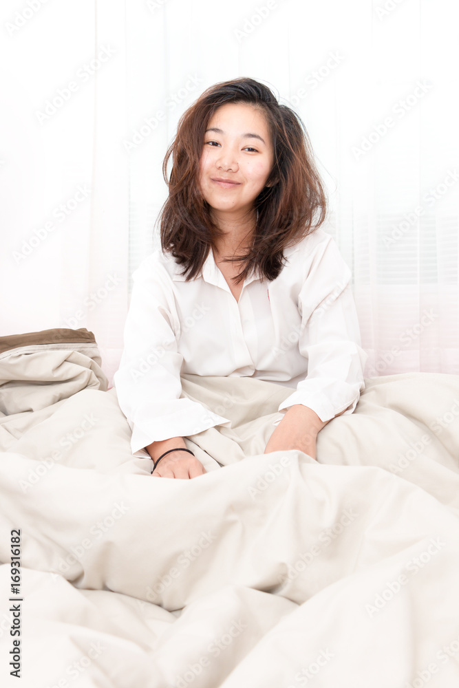 Beautiful woman waking up in her bed in the bedroom, she is smiling after wake up. Beautiful woman waking up in her bed in the bedroom, she is smiling after wake up.