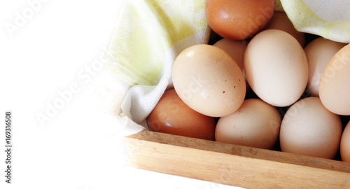 fresh eggs in wooden box isolated on white