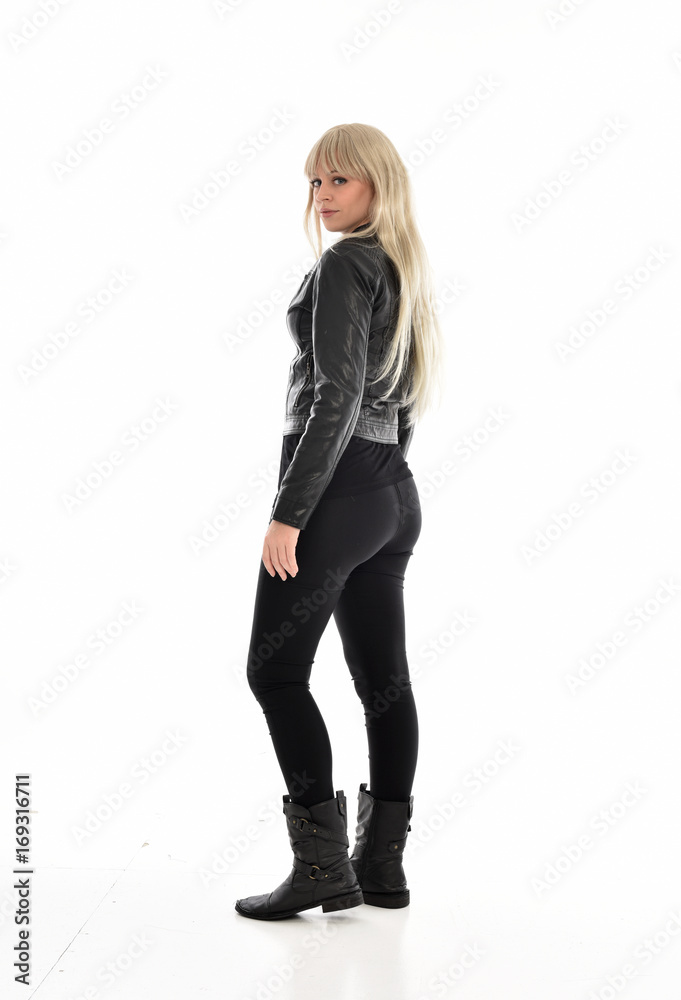 full length portrait of blonde girl wearing black leather outfit, standing pose on white background. full length portrait of blonde girl wearing black leather outfit, standing pose on white background.