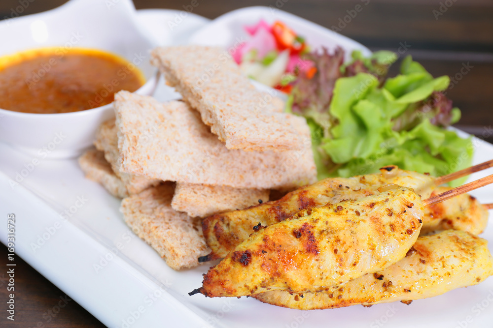 Chicken Satay ,Sate Ayam with Peanut Sauce and bread , Asian skewers famous food in Malaysia Indonesia and Thailand Chicken Satay ,Sate Ayam with Peanut Sauce and bread , Asian skewers famous food in Malaysia Indonesia and Thailand