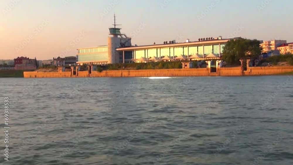 The building of the city river station of the Siberian city, Russia, shooting at the side of the boat at sunset The building of the city river station of the Siberian city, Russia, shooting at the side of the boat at sunset