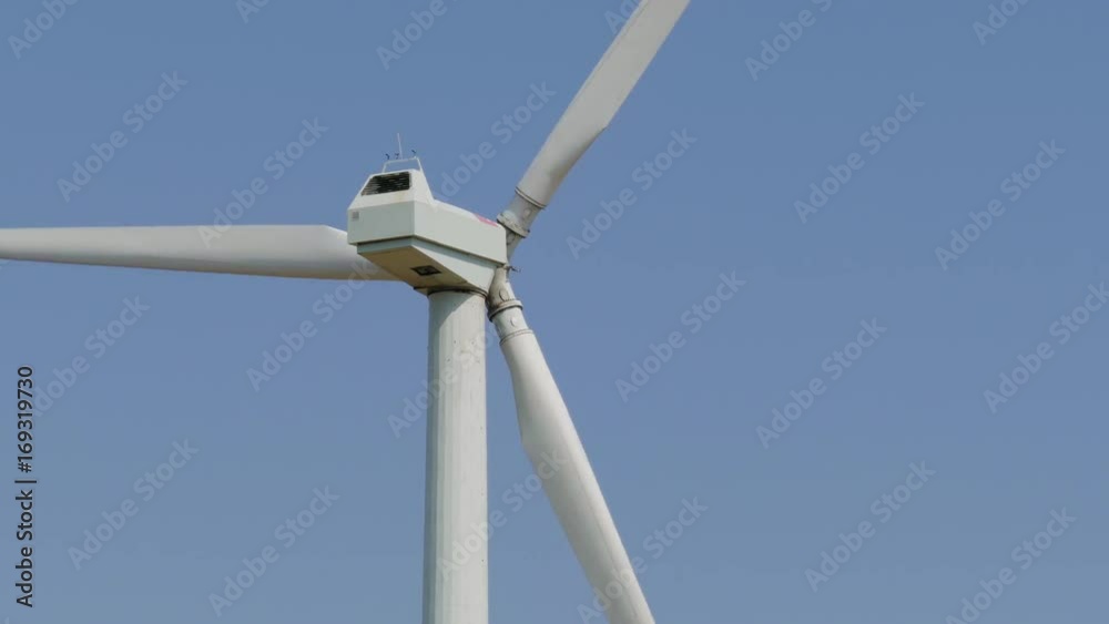 Windmill power generator against sky. Close up Windmill power generator against sky. Close up