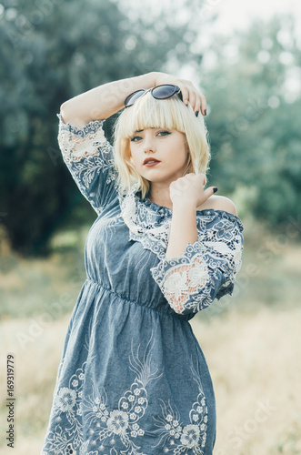 Charming blonde girl blue dress photo